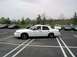 1998 Ford Crown Victoria - A white 1998 Ford Crown Victoria is parked in a lot with several other vehicles visible.