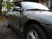 1996 Ford Probe - The side profile of a gray coupe is visible, with a focus on the front wheel well and door panel.