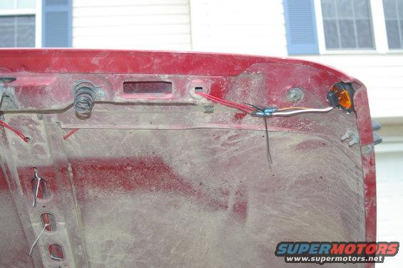 Red Jeep hood interior showing wiring and springs
