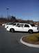 1998 Ford Crown Victoria - Side view of a white 1998 Ford Crown Victoria in a parking lot.