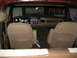 1979 Ford Bronco - The interior of a 1979 Ford Bronco shows brown bucket seats, a wood-grain dashboard, and aftermarket radio.