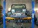 1994 Jeep YJ - This Jeep YJ is on a lift, undergoing front-end work with its axles exposed.