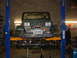 1994 Jeep YJ - A green Jeep Wrangler is shown on a lift in a garage, equipped with a front-mounted winch.