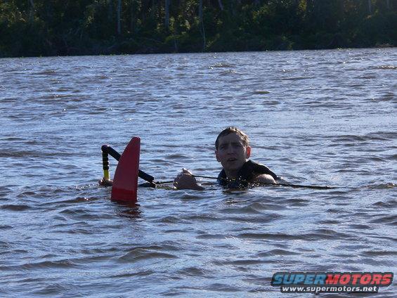 Person in water holding ski rope and tow handle