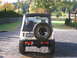 1987 Suzuki Samurai - Rear view of a 1987 Suzuki Samurai parked on a gravel driveway.