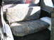 1987 Suzuki Samurai - The interior of a vehicle shows rear bench seats with camouflage upholstery.