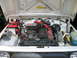 1987 Suzuki Samurai - The engine bay of a 1987 Suzuki Samurai features red spark plug wires and an aftermarket air filter.