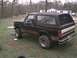 1988 Ford Bronco - This black 1988 Ford Bronco features a distinctive red and white stripe along its side and rear.