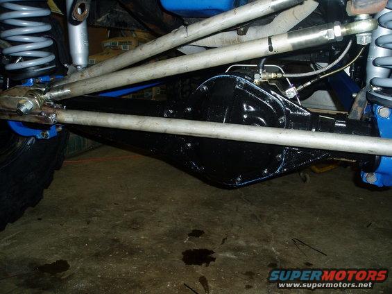 Rear axle assembly with suspension components and brake lines