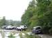 1989 Ford Bronco - Several trucks and SUVs are stuck or driving through a muddy off-road course.