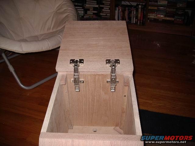 Unfinished wooden center console with hinges, interior view