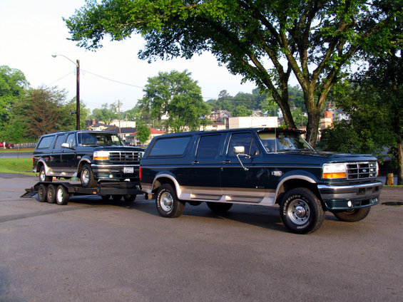 1995 Ford C-150 (Centurion Conversions) SUV on a trailer, another identical SUV parked next to it