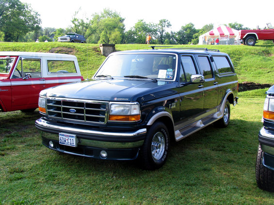 Dark blue 1995 Ford C-150 Centurion Conversions SUV, 3/4 front view. License plate 6DW-C11