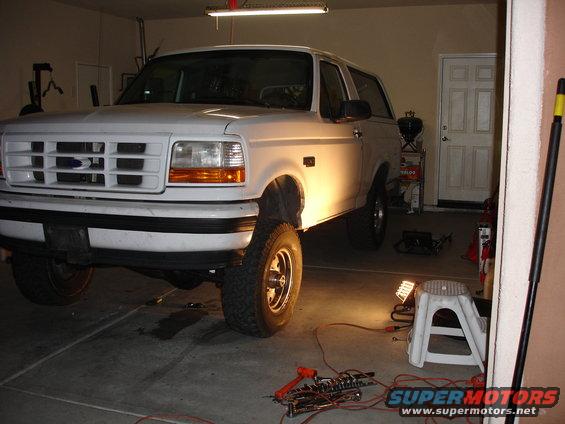 1996 Ford Bronco parked in a garage with tools on the floor