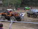1995 Ford Bronco - Several modified off-road vehicles are gathered at an outdoor event, possibly a mud park.