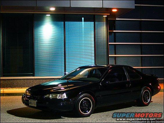 1997 Ford Thunderbird coupe parked outside a building at night
