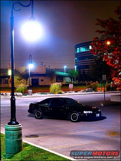 Black 1997 Ford Thunderbird parked at night, 3q-front view
