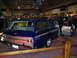 1993 Ford Taurus - A custom blue station wagon is displayed indoors with its doors open, attracting attention from onlookers.