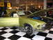 1993 Ford Taurus - A lime green 1970 Ford Mustang coupe is displayed with its hood open, revealing the engine bay.
