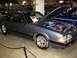 1993 Ford Taurus - Gray coupe with hood and trunk open, revealing a custom engine and drag racing tires. The vehicle's body style suggests it is not a 1993 Fo…