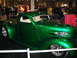 1993 Ford Taurus - A shiny green custom pickup truck is showcased indoors, possibly at a car show.