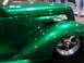 1993 Ford Taurus - A custom green hot rod is displayed indoors, showing off its shiny paint and chrome accents.