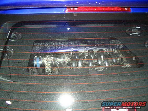 Custom intake manifold with Ford logo visible through rear window