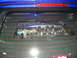 1993 Ford Taurus - A custom intake manifold with a Ford logo is visible through the rear window of a blue vehicle.