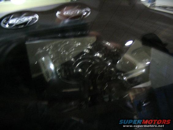 Engine bay with chrome accents and some text on a component