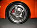 1993 Ford Taurus - Custom wheel and red brake caliper detail on an orange car.