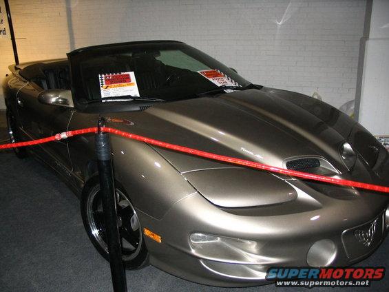 Convertible Pontiac Firebird Trans Am with a brown metallic paint job