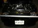 1993 Ford Taurus - Engine bay of a black car, chrome components and a custom license plate reading 'PRJKTWFT'.