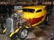 1993 Ford Taurus - This custom hot rod features a prominent exposed engine and a vibrant chili pepper flame graphic along its side.