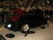 1993 Ford Taurus - Black convertible hot rod with red interior on display at an indoor event.
