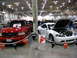1993 Ford Taurus - White coupe and red pickup truck displayed at an indoor event. The coupe's hood is open, revealing the engine.