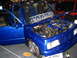 1993 Ford Taurus - Customized blue pickup truck on display, showing off its engine and interior modifications.