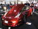 1993 Ford Taurus - This red sports car, likely a C3 Corvette, is displayed with its hood open at an indoor event.
