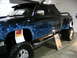 1993 Ford Taurus - Customized pickup truck with flame graphics and "RESURRECTION" text on its side.