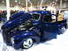 1993 Ford Taurus - A custom blue pickup truck is displayed with its hood and door open, revealing the engine and interior.