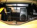 1993 Ford Taurus - The trunk of a car is outfitted with a custom audio system multiple speakers and amplifiers.