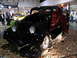 1993 Ford Taurus - A classic black hot rod coupe with a red interior is showcased indoors.
