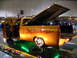 1993 Ford Taurus - This modified pickup truck features custom paint and lighting, displayed indoors at a show.