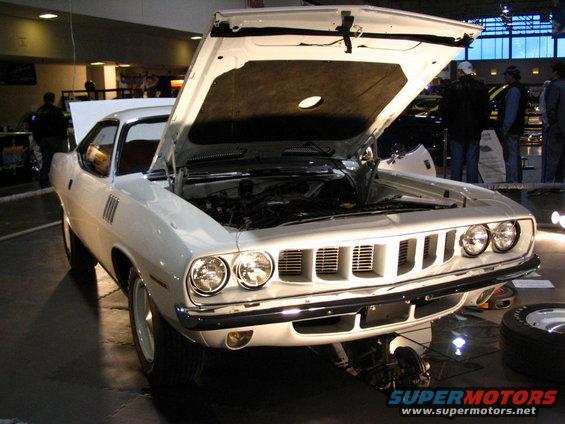 White 1970 Plymouth Barracuda with hood open, showing engine bay