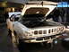 1993 Ford Taurus - White 1970 Plymouth Barracuda displayed indoors with its hood raised.