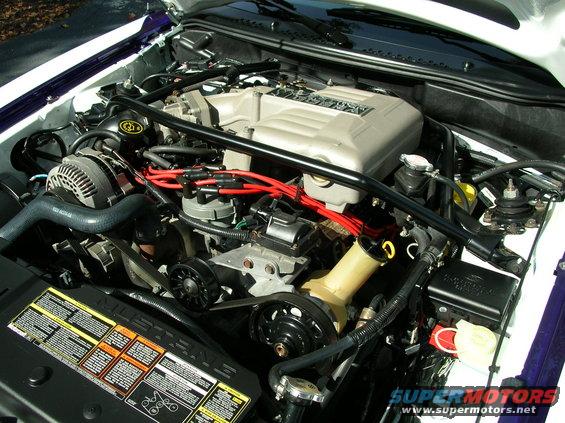 1995 Ford Mustang engine bay with V8 engine and red spark plug wires