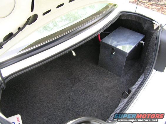 Trunk interior with a metal tank and red wire