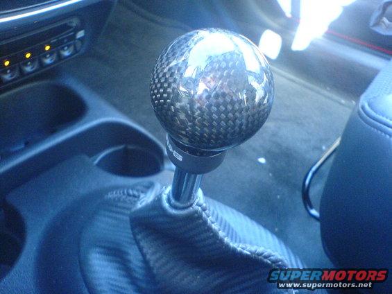 Carbon fiber shift knob on a metal stick with a matching shift boot