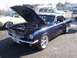 2002 Ford Mustang - A classic dark blue Ford Mustang from the mid-1960s is displayed with its hood open, revealing the engine compartment.