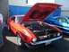 2002 Ford Mustang - A red 1971 Ford Mustang Mach 1 is displayed with its hood open, revealing the engine. Another Mustang is visible in the background.