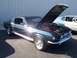 2002 Ford Mustang - Classic Mustang Fastback with hood up, parked next to another vehicle. A dog is visible in the other car's window.